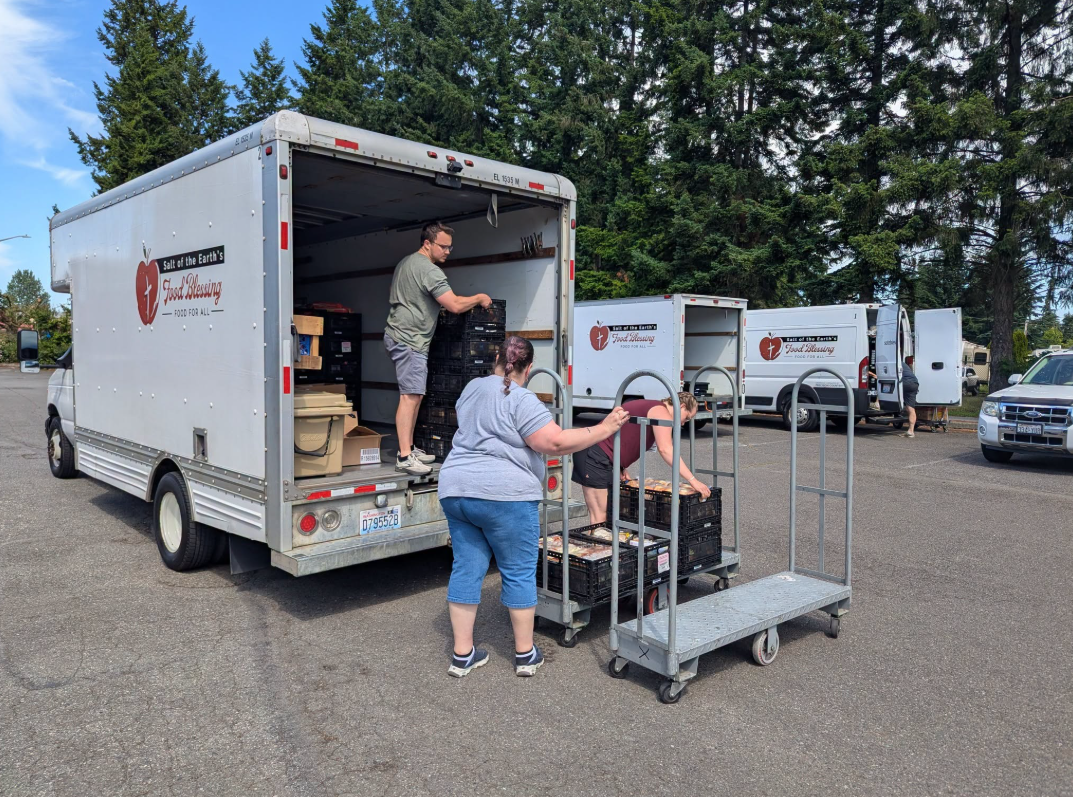 Volunteers unloading food trucks for Salt of the Earth Food Blessing