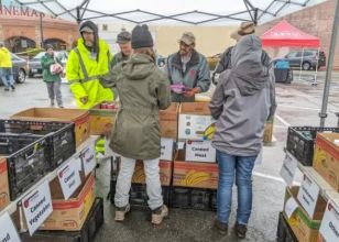 Volunteers welcoming people at a community food event