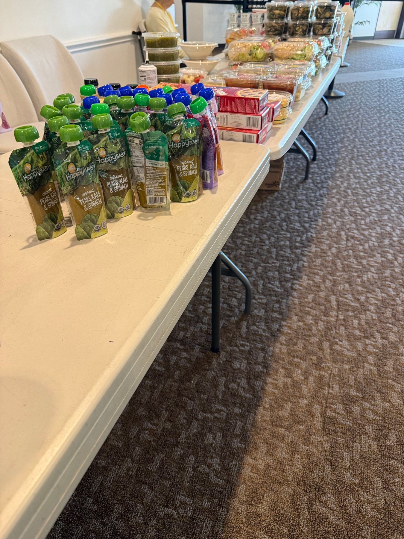 Baby food and prepared foods arranged on tables at Hope Church
