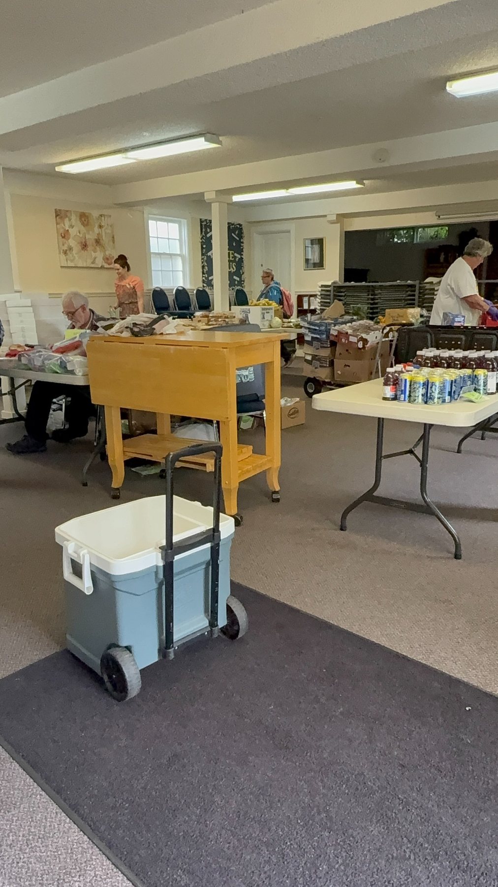 Volunteers preparing food inside Midnight Cry Church before the Sunday distribution
