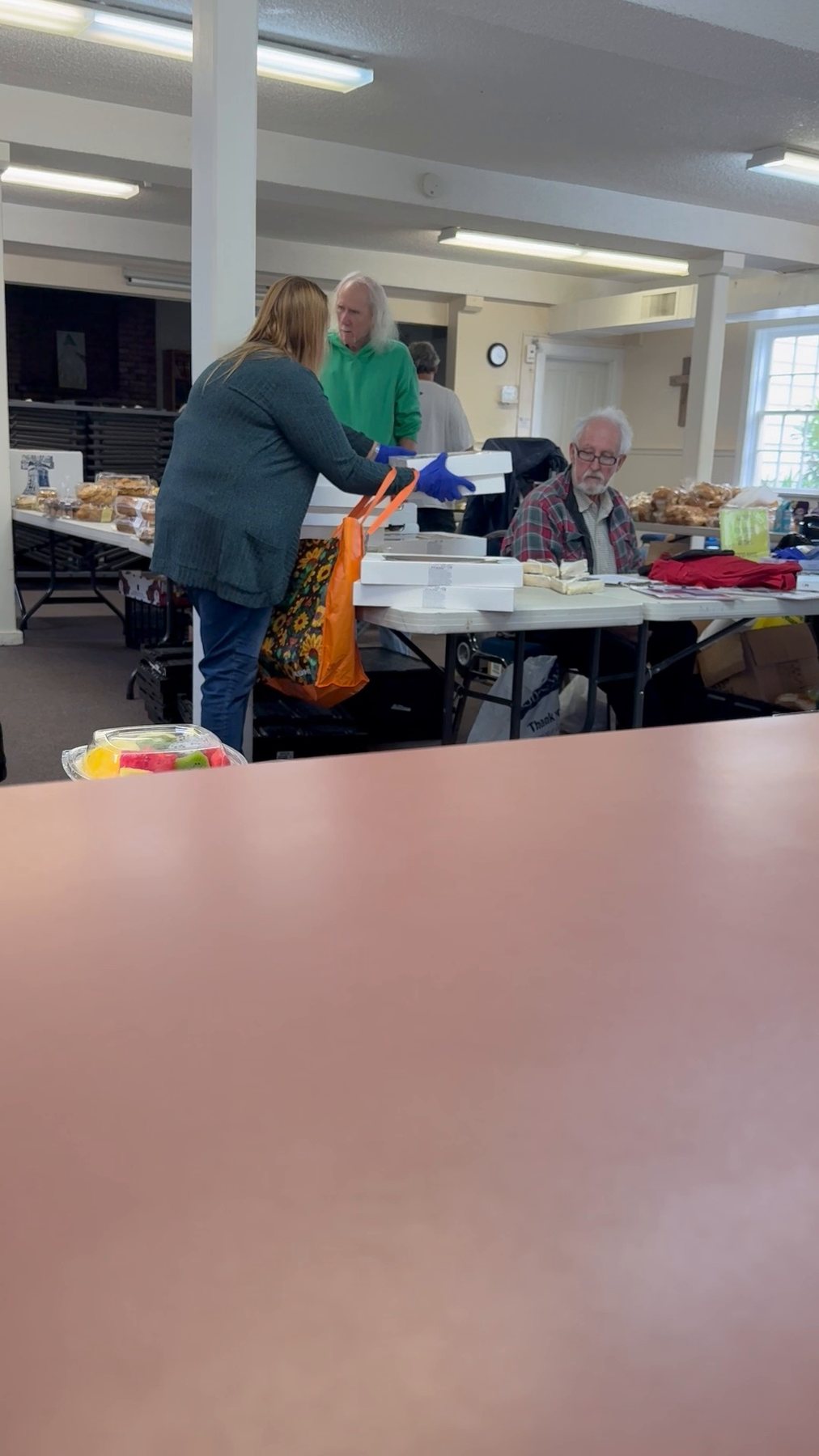 Food and volunteers inside the Midnight Cry distribution room