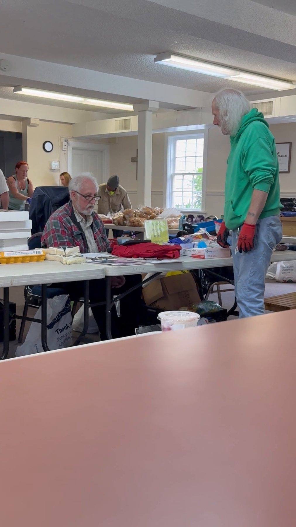Volunteers and guests interacting during the Sunday distribution at Midnight Cry
